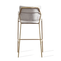 Hoher gepolsterter Hocker mit goldenen Beinen